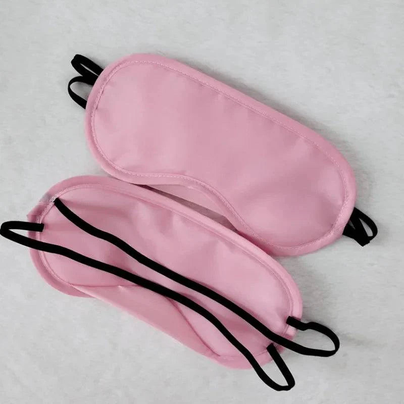 Pink padded blindfolds with black elastic straps for sensory play in leather flogger bondage set