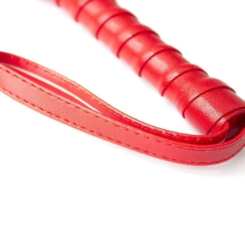 Red leather flogger handle with stitched wrist strap for BDSM sensory play
