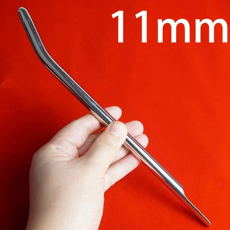 Hand holding a polished stainless steel long urethral sound rod with a slight curve, 11mm diameter, on a red background