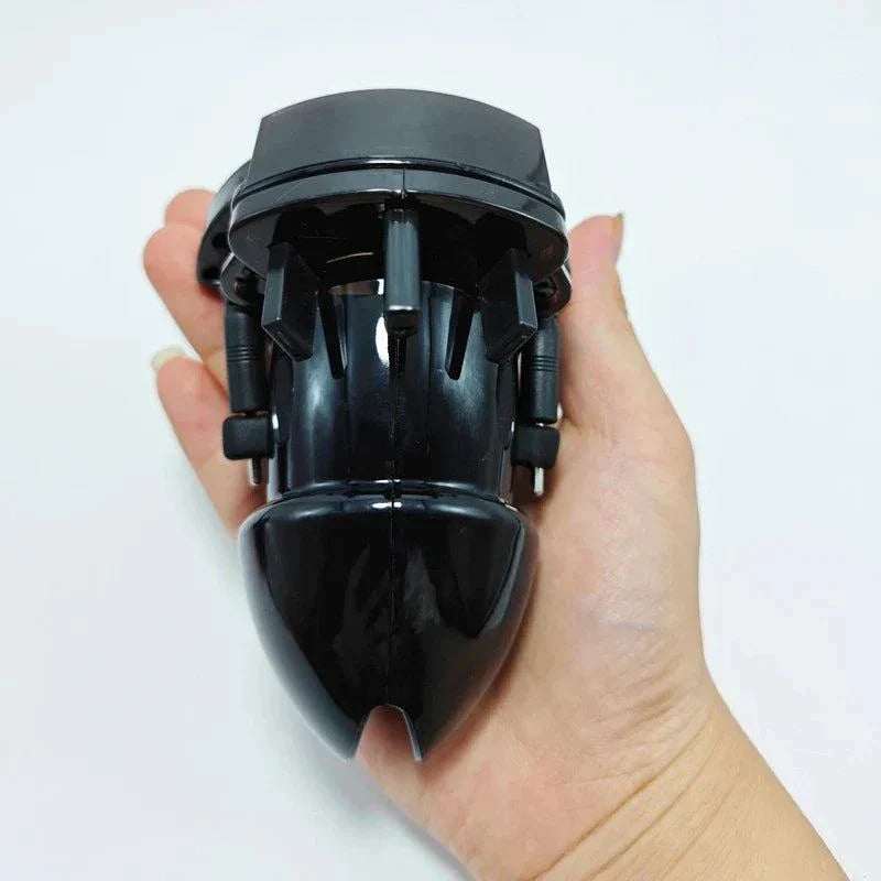 Electric Shock Penis Plug and Chastity Cage with urethral dilator held in hand, black adult toy for stimulation and restraint