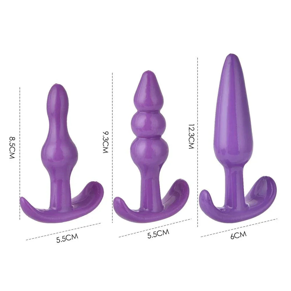 Set of three purple silicone anal plugs with varying sizes and shapes for BDSM play