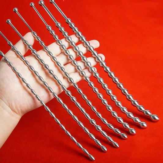 Curved stainless steel urethral insert penis plugs with beaded shafts displayed on hand