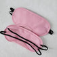 Pink padded blindfolds with black elastic straps for sensory play in leather flogger bondage set