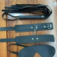 Couples BDSM bondage set with mask, feather tickler, handcuffs, and ankle restraints on wooden surface
