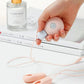 Enhancer nipple stimulator breast massage clamp vibrator for women in hand with lotion bottle and books background