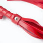 Close-up of red leather flogger whip for sensory play and bondage set