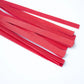 Close-up of red leather flogger strips for sensory BDSM play and impact.