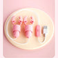 Pink USB rechargeable nipple clamps vibrator with remote control on beige background