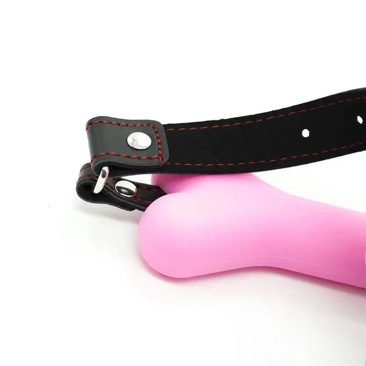 Adjustable soft harness mouth silicone dog-bone ball gag in pink with black strap for bondage restraint