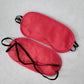 Red padded blindfolds with black straps for sensory play and bondage set